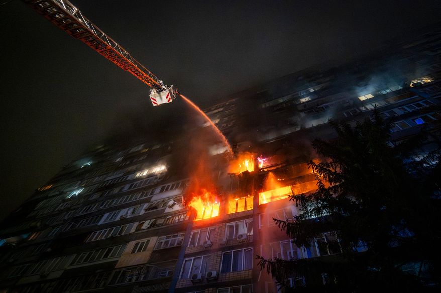 Emergency services personnel work to extinguish a fire following a Russian attack in Kyiv, Ukraine, Friday, Oct. 10, 2025. (AP Photo/Dan Bashakov)
