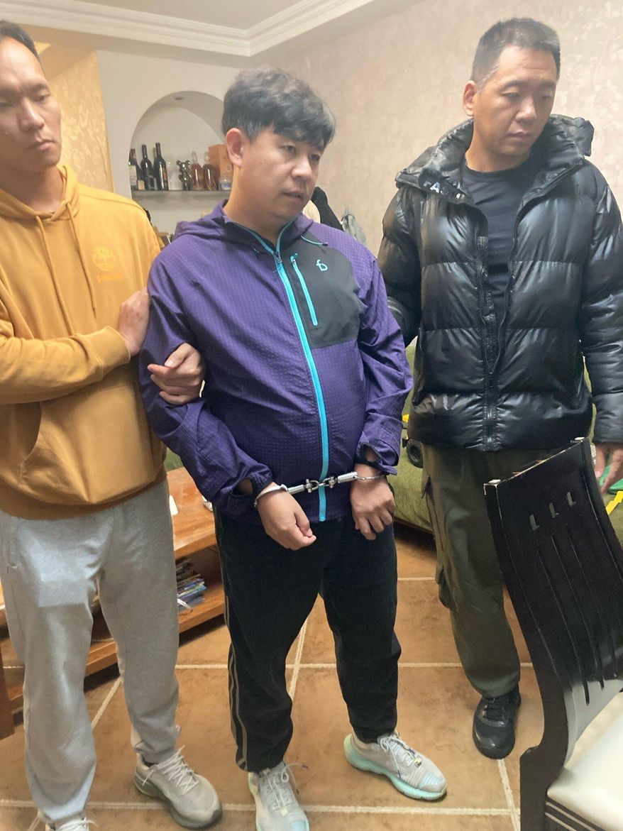 This photograph provided by pastor Sean Long of Zion Church shows shows pastor Sun Cong of Zion Church standing, wearing handcuffs, after being detained by police at his home in Beijing, China on Friday, Oct. 10, 2025. (Sean Long via AP)