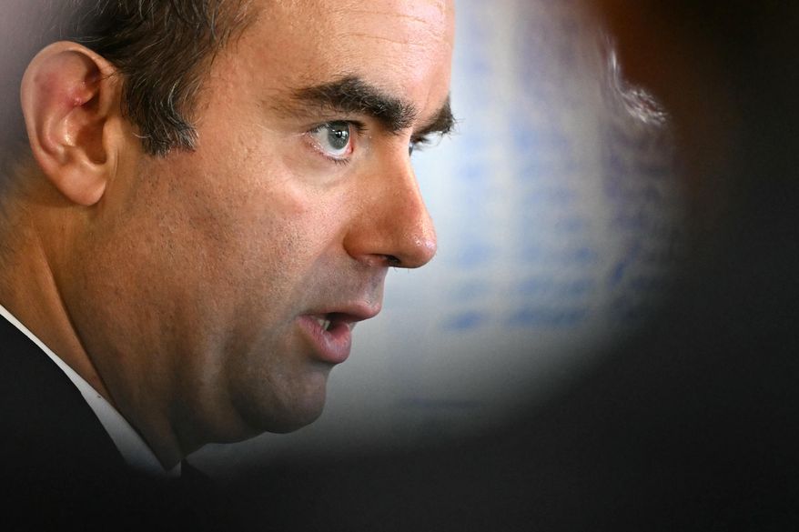 Reappointed French Prime Minister Sebastien Lecornu looks on as he visits a police station in L'Hay-les-Roses, outside Paris, Saturday, Oct. 11, 2025. (Martin Lelievre, Pool Photo via AP)