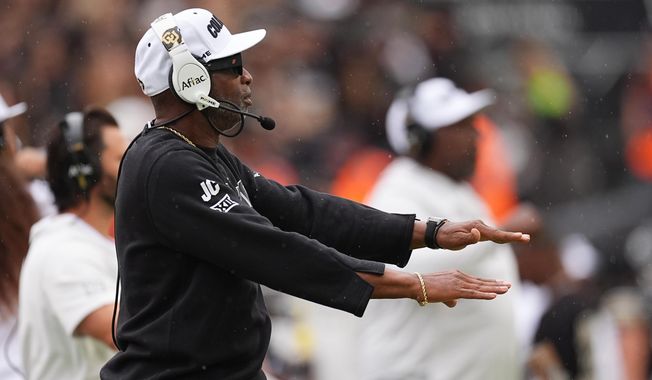 Colorado head coach Deion Sanders signals to decline a penalty against Iowa State in the first half of an NCAA college football game Saturday, Oct. 11, 2025, in Boulder, Colo. (AP Photo/David Zalubowski)