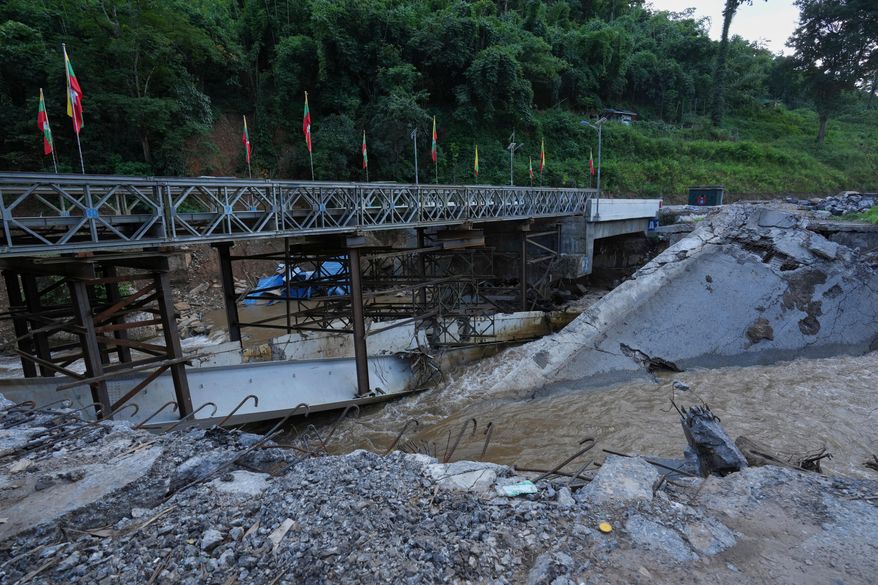 In this photo taken during a trip supervised by pro-military Myanmar media, the damaged Gotwin bridge is seen in Kawnghkio township, northern Shan State, Myanmar, Friday, Oct. 10, 2025. (AP Photo/Aung Shine Oo)