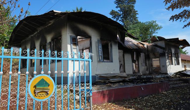In this photo taken during a trip supervised by pro-military Myanmar media, a damaged government residence is seen in Kyaukme, northern Shan State, Myanmar, Friday, Oct. 10, 2025. (AP Photo/Aung Shine Oo)