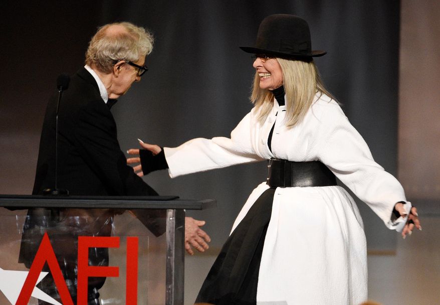 FILE - Filmmaker Woody Allen, left, greets actress Diane Keaton onstage to present her with the 45th AFI Life Achievement Award on June 8, 2017, in Los Angeles. (Photo by Chris Pizzello/Invision/AP, File)