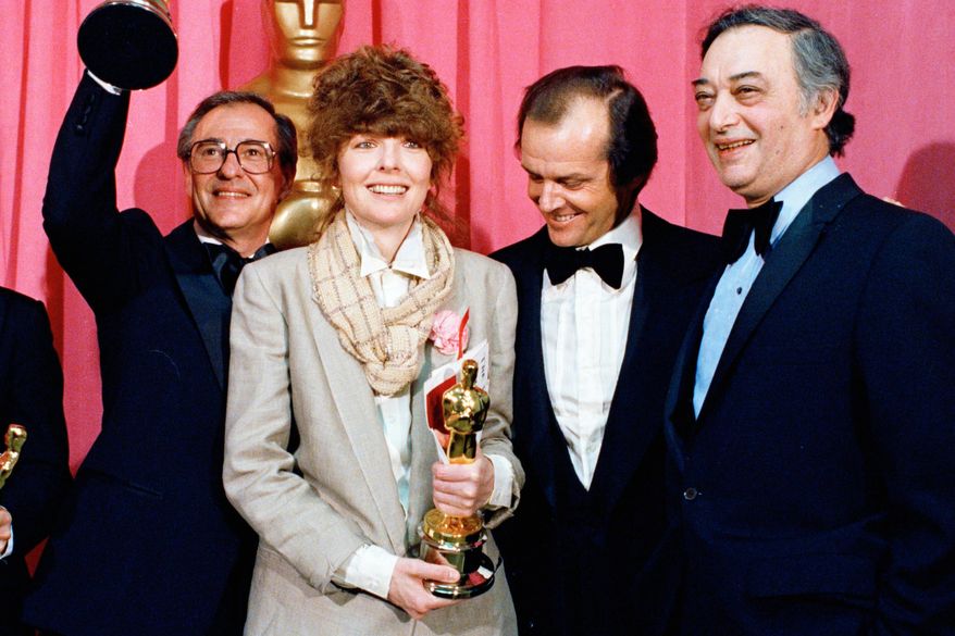 FILE - Oscar winners Charles H. Joffe, winner of best picture for "Annie Hall," left, and Diane Keaton, winner of best actress for "Annie Hall," poses with presenter Jack Nicholson, and producer Jack Rollins at the Academy Awards in Los Angeles on April 3, 1978. (AP Photo, File)
