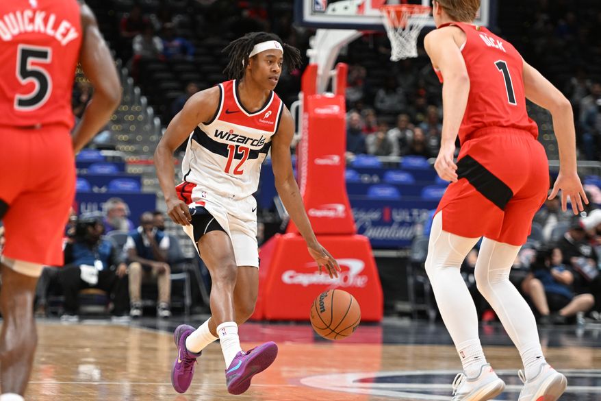 Washington Wizards guard Tre Johnson (12) bringing the ball up court during the first quarter of a preseason NBA game against the Toronto Raptors at Capital One Arena in Washington D.C., October 12, 2025. (Photo for the Washington Times)