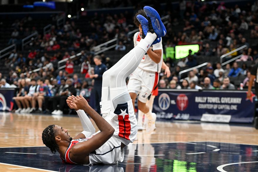 Washington Wizards center Alex Sarr (20) on the ground during the first quarter of a preseason NBA game against the Toronto Raptors at Capital One Arena in Washington D.C., October 12, 2025. (Photo for the Washington Times)