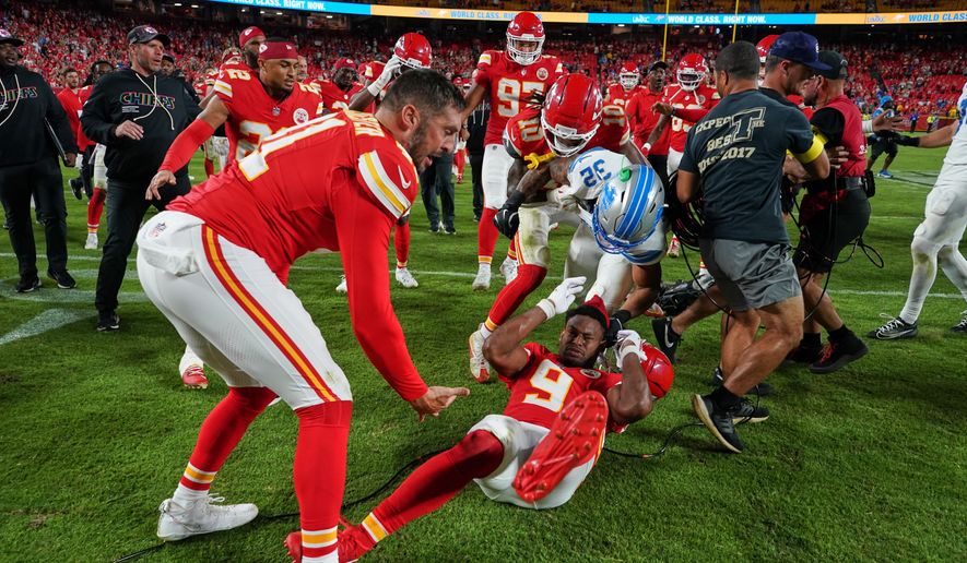 Detroit Lions defensive back Brian Branch (32) fights with Kansas City Chiefs wide receiver JuJu Smith-Schuster (9) while be held back by Chiefs' James Winchester, left, and Isiah Pacheco (10) following an NFL football game Sunday, Oct. 12, 2025, in Kansas City, Mo. (AP Photo/Ed Zurga)