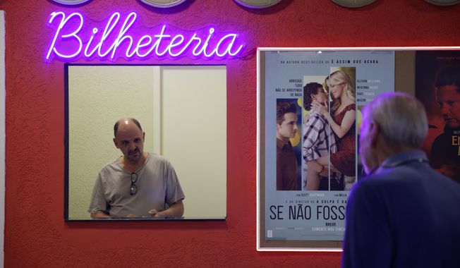 Carlos Costa sells movie tickets at his Cine LT3 in an old parking garage in Sao Paulo, Thursday, Oct. 9, 2025. (AP Photo/Ettore Chiereguini)