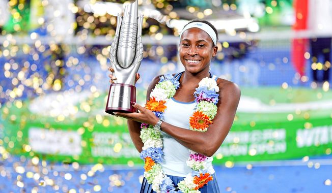 Coco Gauff of the United States celebrates with her trophy after defeating her compatriot Jessica Pegula in the women's singles final at the WTA Wuhan Open in Wuhan in central China's Hubei province Sunday, Oct. 12, 2025. (Chinatopix Via AP) CHINA OUT