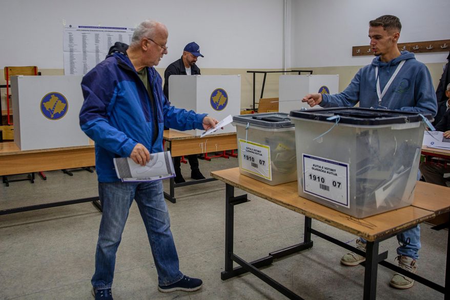 Voters cast their ballot for the municipal elections in Pristina, Kosovo on Sunday, Oct. 12, 2025. (AP Photo/Visar Kryeziu)