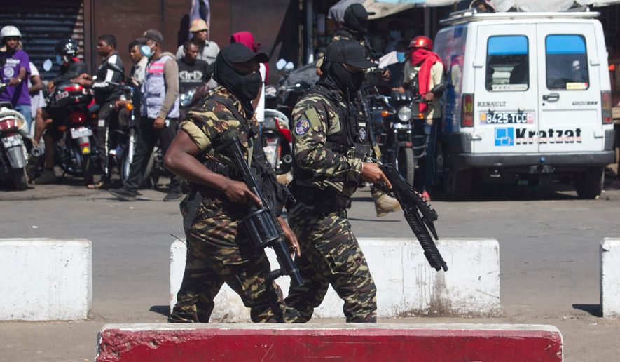 Police patrol the streets during a protest calling for the president to step down in Antananarivo, Madagascar, Thursday, Oct. 9, 2025. (AP Photo/Alexander Joe)