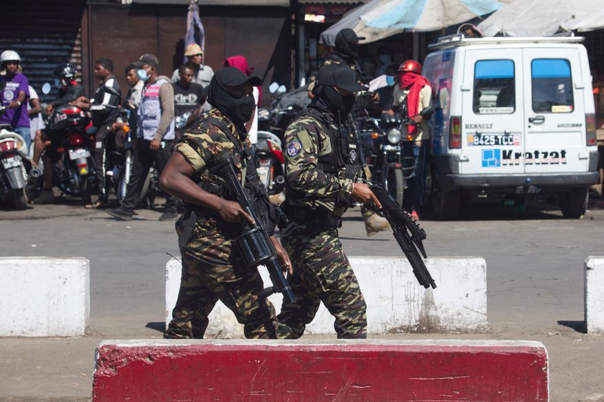 Police patrol the streets during a protest calling for the president to step down in Antananarivo, Madagascar, Thursday, Oct. 9, 2025. (AP Photo/Alexander Joe)