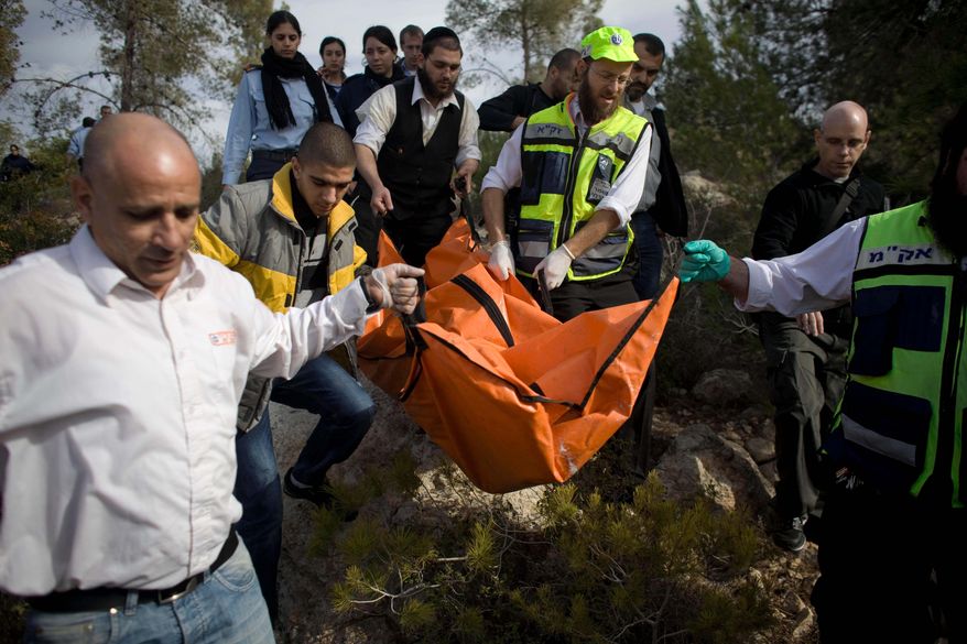 FILE - Israeli rescue workers carry the body of U.S. tourist Kristine Luken after she was found in a wooded area near the village of Mata, outside Jerusalem, Sunday, Dec. 19, 2010. (AP Photo/Tara Todras-Whitehill, File)