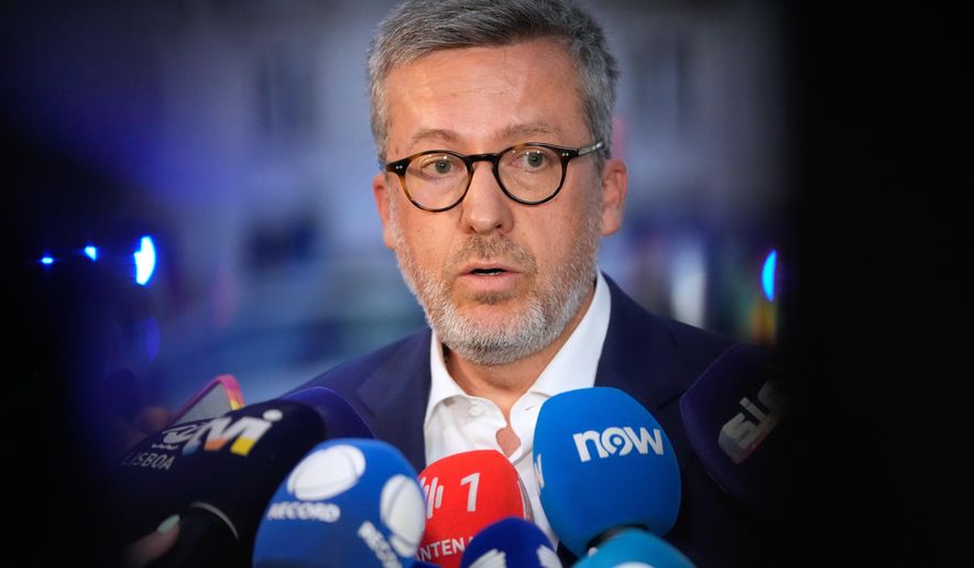 Lisbon Mayor Carlos Moedas speaks to journalists at the site of a derailed electric streetcar in downtown Lisbon, Wednesday, Sept. 3, 2025. (AP Photo/Armando Franca)