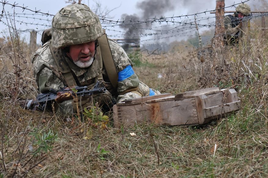 In this photo provided by Ukraine's 65th Mechanized Brigade press service, recruits attend drills at a training ground in the Zaporizhzhia region, Ukraine, Saturday, Oct. 11, 2025. (Andriy Andriyenko/Ukraine's 65th Mechanized Brigade via AP)
