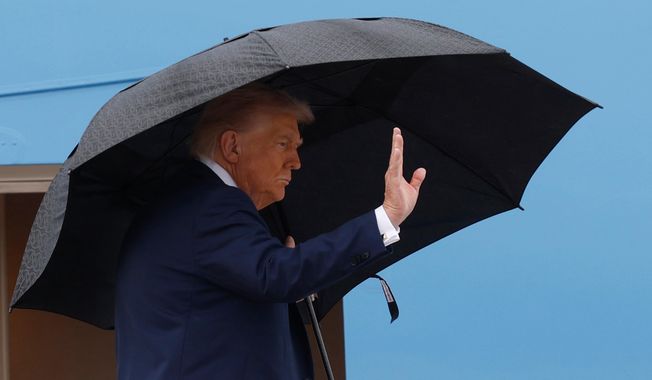 President Donald Trump waves from the stairs of Air Force One as he boards upon his arrival at Joint Base Andrews, Md., Sunday, Oct. 12, 2025, as he travels to the Middle East. (AP Photo/Luis M. Alvarez)