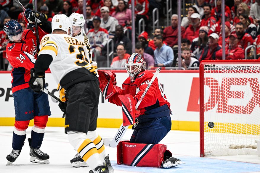 A bouncing puck sneaks past Washington Capitals goalie Logan Thompson (48) to give the Boston Bruins a 1-0 lead during the season opener at Capital One Arena, Washington, D.C., October 8, 2025. (Photo by Brian Murphy for the Washington Times)