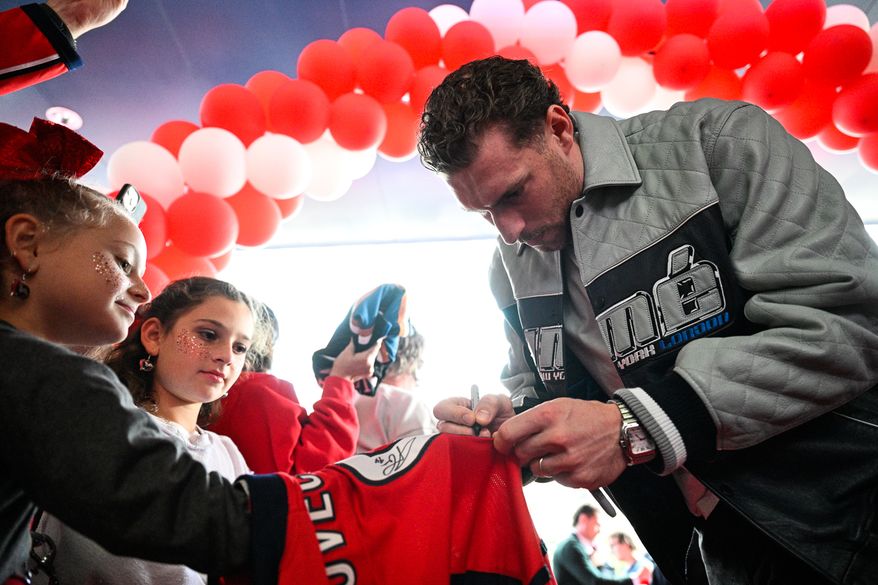 Washington Capitals forward Pierre-Luc Dubois (80) signs an autograph for a junior Caps fan prior to facing the Boston Bruins at Capital One Arena, Washington, D.C., October 8, 2025. (Photo by Brian Murphy for the Washington Times)