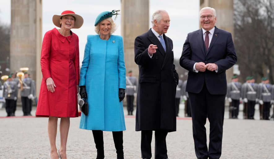 FILE - German President Frank-Walter Steinmeier, right, and his wife Elke Buedenbender, left, welcome Britain's King Charles III and Queen Camilla, in front of the Brandenburg Gate in Berlin, March 29, 2023. (AP Photo/Matthias Schrader, File)