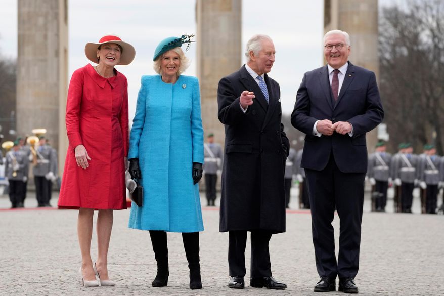 FILE - German President Frank-Walter Steinmeier, right, and his wife Elke Buedenbender, left, welcome Britain's King Charles III and Queen Camilla, in front of the Brandenburg Gate in Berlin, March 29, 2023. (AP Photo/Matthias Schrader, File)