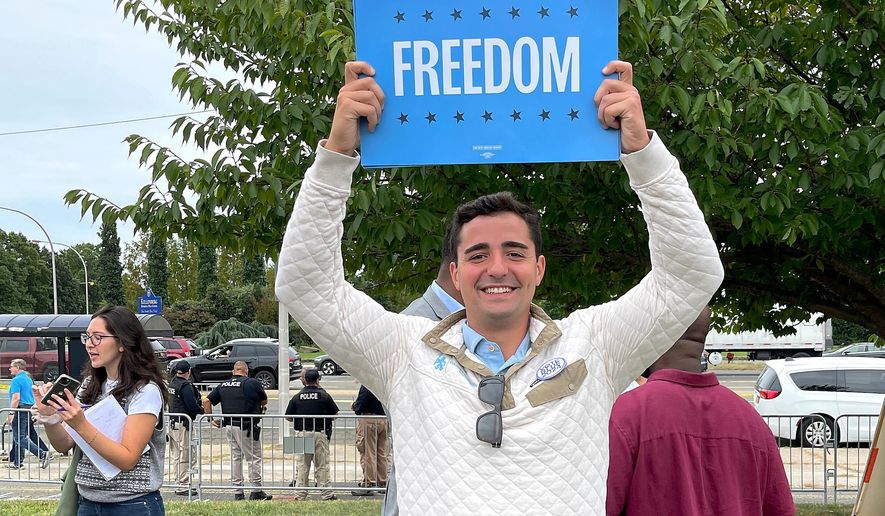 Petros Krommidas holds up a sign during an anti-Trump rally at Nassau Coliseum, Wednesday, Sept. 18, 2024, in Uniondale, N.Y. (Mark DeFrancesco via AP)