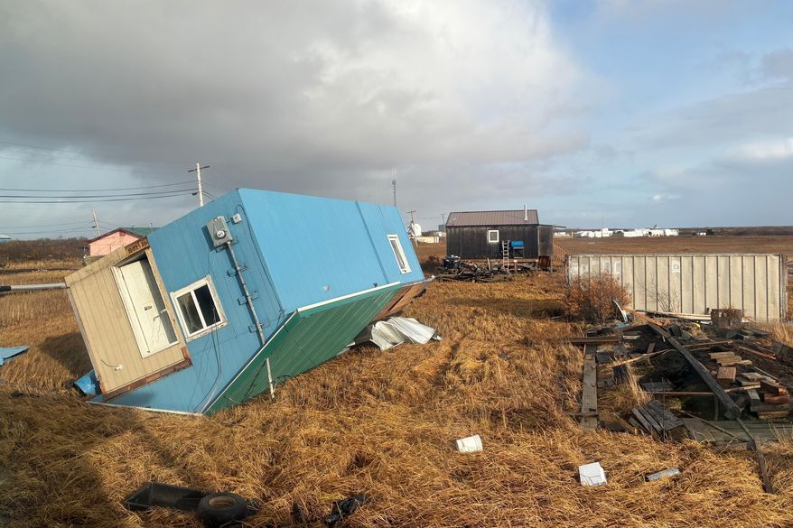 An unoccupied home rests on its roof after being knocked over in Kotlik, Alaska, on Sunday, Oct. 12, 2025, after the remnants of Typhoon Halong hit western Alaska. (AP Photo/Adaline Pete)