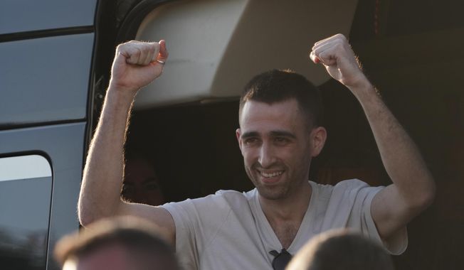 Freed Israeli hostage Avinatan Or gestures from a van as he arrives at Beilinson hospital in Petah Tikva, Israel, after he was released from Hamas captivity in the Gaza Stripl, Monday, Oct. 13, 2025. (AP Photo/Francisco Seco)