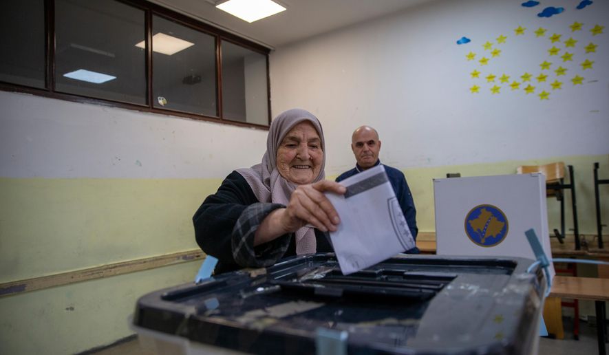 Voters cast their ballot for the municipal elections in Pristina, Kosovo on Sunday, Oct. 12, 2025. (AP Photo/Visar Kryeziu)