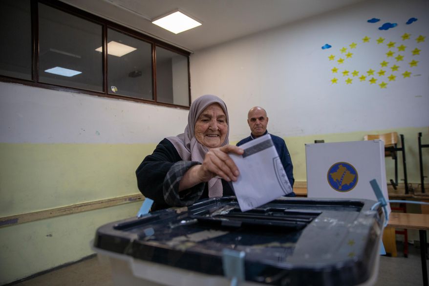 Voters cast their ballot for the municipal elections in Pristina, Kosovo on Sunday, Oct. 12, 2025. (AP Photo/Visar Kryeziu)