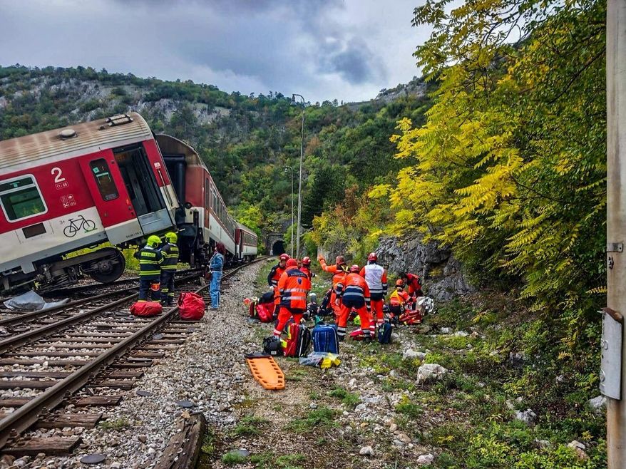 In this photo released by Slovak Police, rescue workers treat wounded passengers after a train crash near Roznava, Slovakia, Monday, Oct. 13, 2025. (Slovak Police via AP)