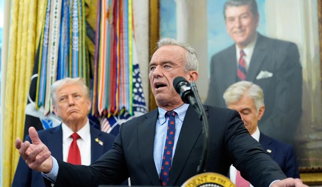 Secretary of Health and Human Services Robert F. Kennedy, Jr., speaks in the Oval Office of the White House, Tuesday, Sept. 30, 2025, in Washington, as President Donald Trump, left, and Mehmet Oz, Administrator for the Centers for Medicare & Medicaid Services, look on. (AP Photo/Alex Brandon)