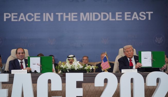 President Donald Trump and Egypt's President Abdel-Fattah el-Sissi hold signed documents during a summit to support ending the more than two-year Israel-Hamas war in Gaza after a breakthrough ceasefire deal, Monday, Oct. 13, 2025, in Sharm El Sheikh, Egypt. (AP Photo/Evan Vucci)
