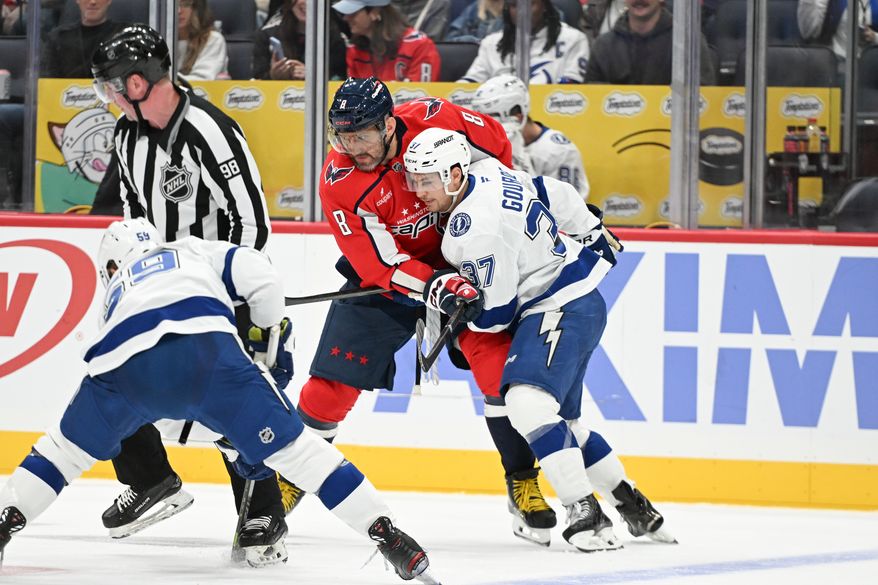 Washington Capitals left wing Alex Ovechkin (8) grappling with Tampa Bay Lightning center Yanni Gourde (37) during a face off during the first period of an NHL game at Capital One Arena in Washington D.C., October 14, 2025. (Photo for the Washington Times)