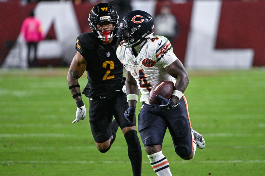 Chicago Bears running back D’Andre Swift (4) races past Washington Commanders cornerback Marshon Lattimore (2) for a 55-yard touchdown reception at Northwest Stadium in Landover, Maryland, October 13, 2025. (Photo by Brian Murphy for the Washington Times)