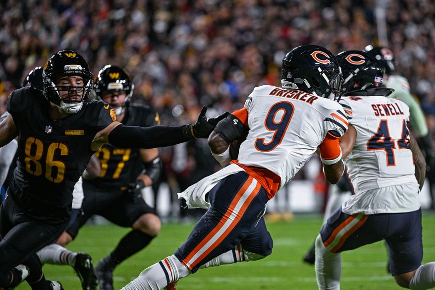 Chicago Bears defensive back Jaquan Brisker (9) races past Washington Commanders tight end Zach Ertz (86) after intercepting a pass attempt by quarterback Jayden Daniels (5) at Northwest Stadium in Landover, Maryland, October 13, 2025. (Photo by Brian Murphy for the Washington Times)