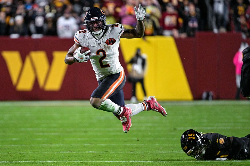 Chicago Bears receiver DJ Moore (2) evades Washington Commanders safety Jeremy Reaves (39) at Northwest Stadium in Landover, Maryland, October 13, 2025. (Photo by Brian Murphy for the Washington Times)