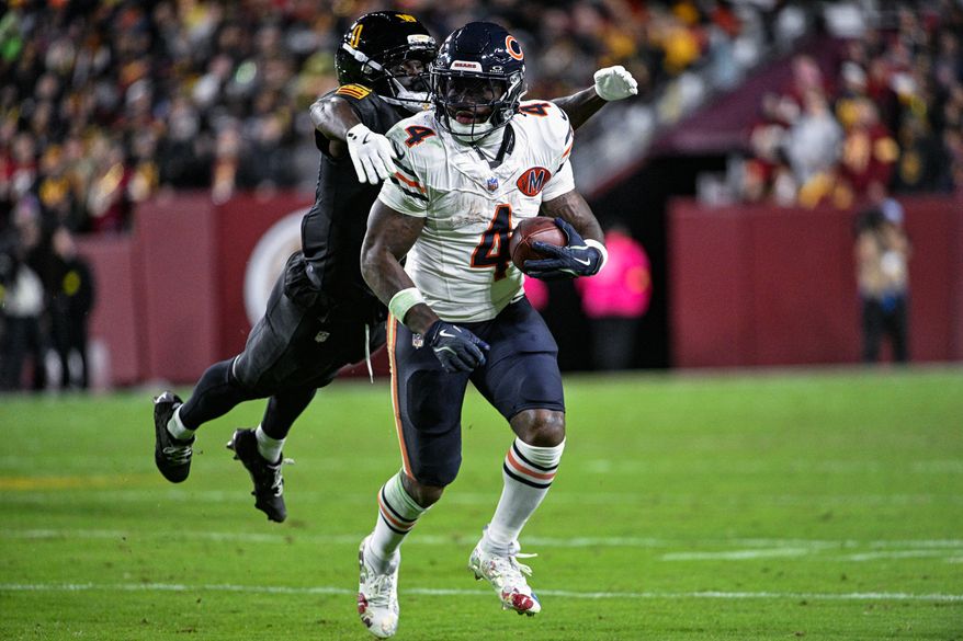 Washington Commanders cornerback Mike Sainristil (0) lunges to tackle Chicago Bears running back D’Andre Swift (4) from behind at Northwest Stadium in Landover, Maryland, October 13, 2025. (Photo by Brian Murphy for the Washington Times)