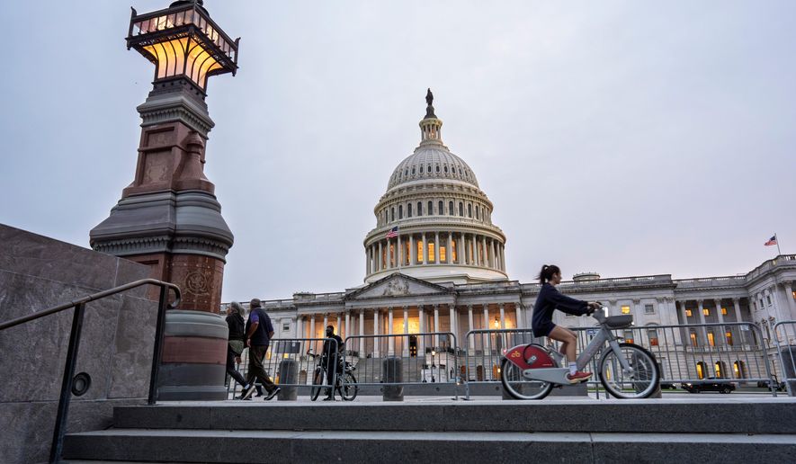 The Capitol is seen at dusk as Democrats and Republicans in Congress are angrily blaming each other and refusing to budge from their positions on funding the government, in Washington, Tuesday, Sept. 30, 2025. (AP Photo/J. Scott Applewhite)