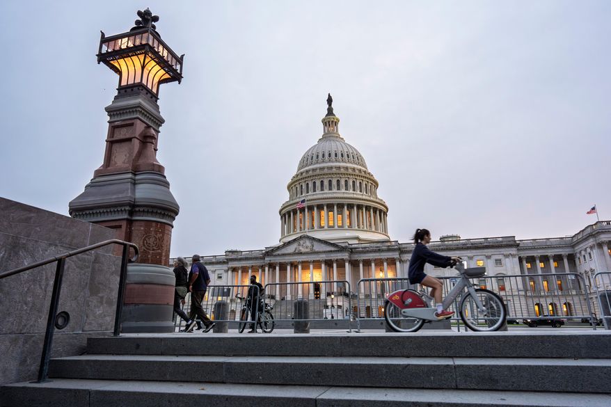 The Capitol is seen at dusk as Democrats and Republicans in Congress are angrily blaming each other and refusing to budge from their positions on funding the government, in Washington, Tuesday, Sept. 30, 2025. (AP Photo/J. Scott Applewhite)
