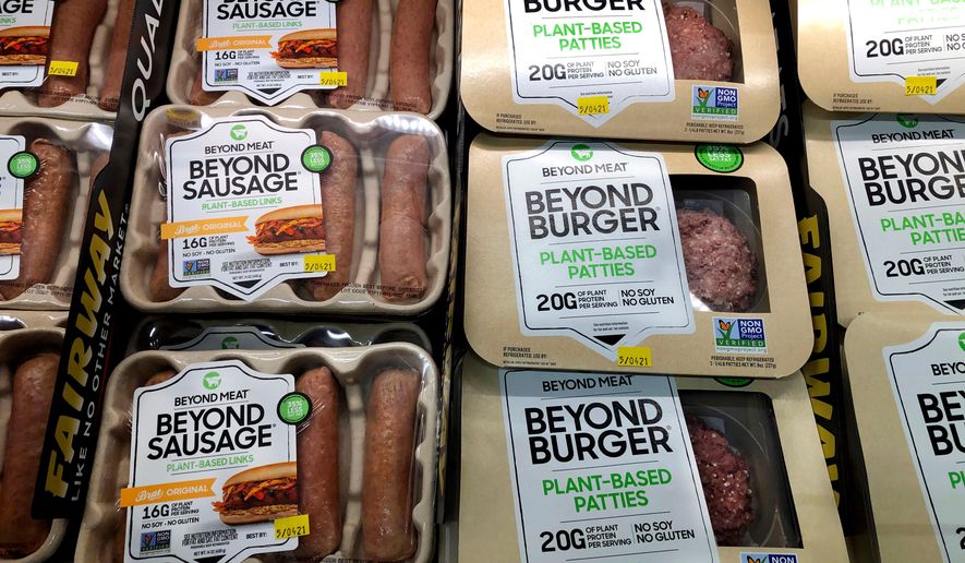 FILE - Packages of Beyond Meat's Beyond Burgers and Beyond Sausage, are shown in this photo, in New York, April 29, 2021. (AP Photo/Richard Drew, File)