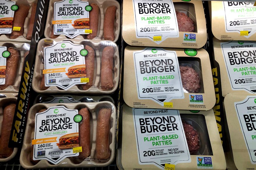 FILE - Packages of Beyond Meat's Beyond Burgers and Beyond Sausage, are shown in this photo, in New York, April 29, 2021. (AP Photo/Richard Drew, File)
