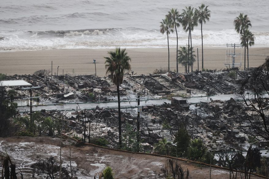 Rain comes down on a neighborhood in the Palisades Fire zone on Tuesday, Oct. 14, 2025, in the Pacific Palisades section of Los Angeles. (AP Photo/Ethan Swope)