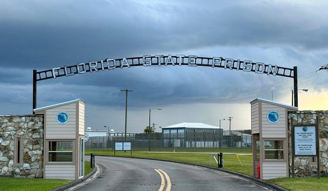 FILE - Clouds hover over the entrance of the Florida State Prison in Starke, Fla., Aug. 3, 2023. (AP Photo/Curt Anderson, File)