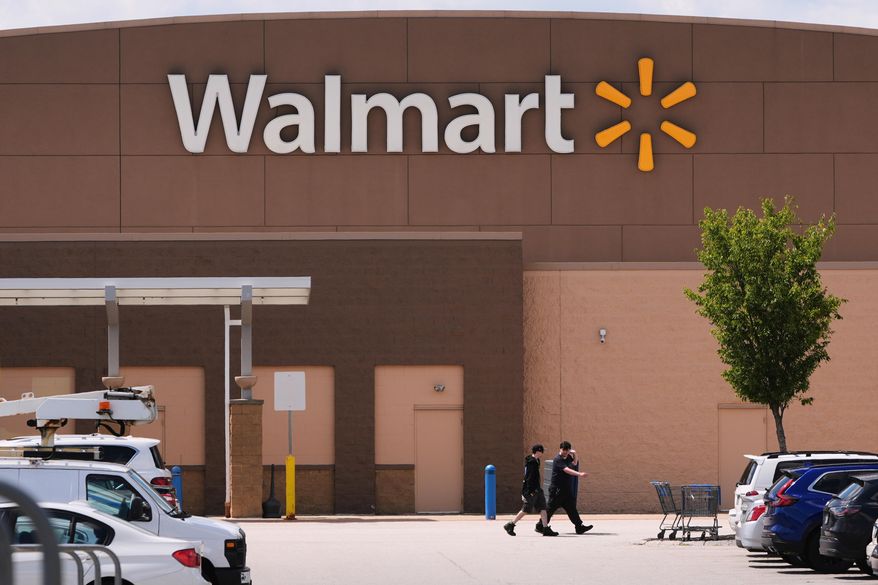 Shoppers walk from the Walmart store, Aug. 14, 2025, in Manchester, N.H. (AP Photo/Charles Krupa, File)
