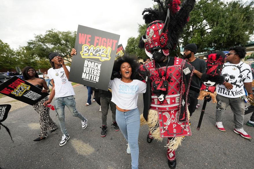 Students and a member of the Zulu Tramps march to a campus polling place on Election Day at Southern University in Baton Rouge, La., Nov. 5, 2024. (AP Photo/Gerald Herbert, File)