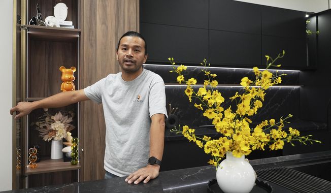 Josh Qian, co-founder of Linq Kitchen, a designer and maker of kitchen cabinets, shows his company's show room and warehouse in City of Industry, Calif., Friday, Oct. 10, 2025. (AP Photo/Damian Dovarganes)