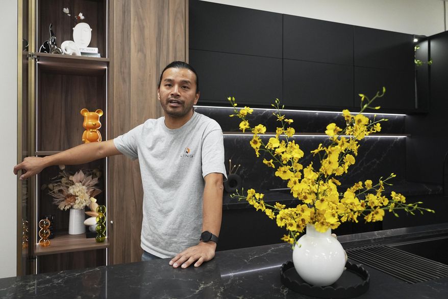 Josh Qian, co-founder of Linq Kitchen, a designer and maker of kitchen cabinets, shows his company's show room and warehouse in City of Industry, Calif., Friday, Oct. 10, 2025. (AP Photo/Damian Dovarganes)