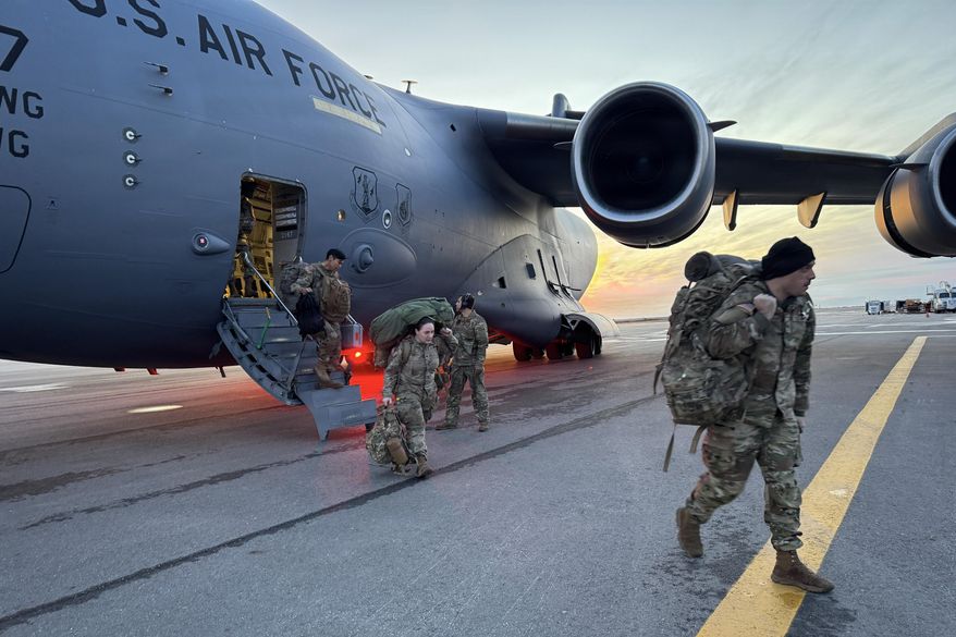 In this photo provided by Alaska National Guard, members of the Alaska National Guard arrive in Kotzebue, Alaska, Monday, Oct. 13, 2025, to support operations responding to the damage caused by Typhoon Halong. (Alaska National Guard via AP)