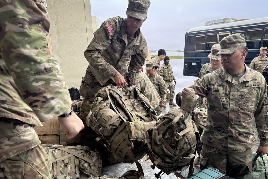 In this photo provided by Alaska National Guard, members of the Alaska National Guard prepare for departure from Joint Base Elmendorf-Richardson in Anchorage, Alaska, Monday, Oct. 13, 2025, during storm response operations after Typhoon Halong's landfall. (Capt. Balinda O'Neal/Alaska National Guard via AP)