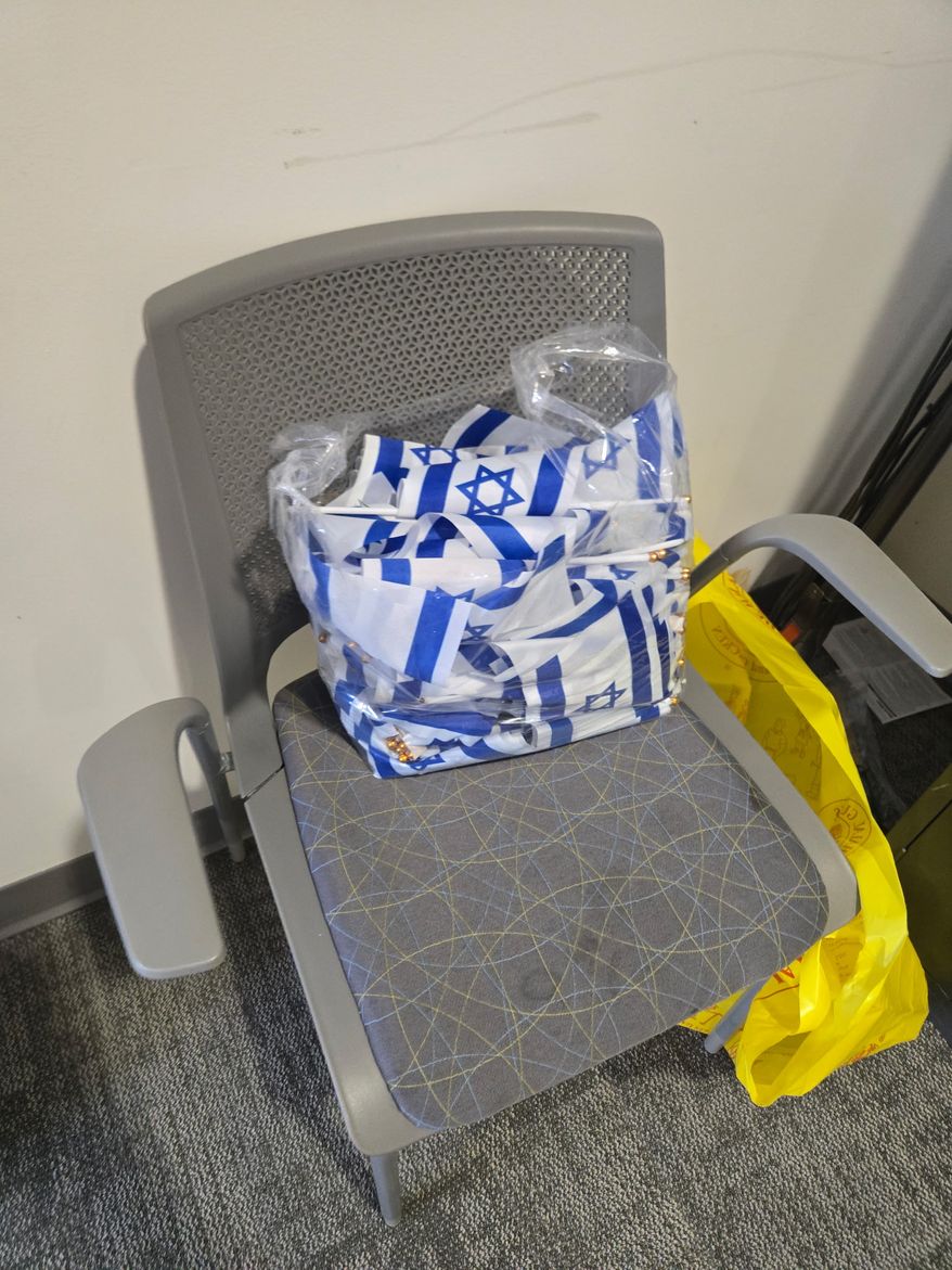 Catholic University of America staff confiscated and bagged Israeli flags that students placed on the campus lawn as a memorial to victims of the Oct. 7, 2023, Hamas terror attack on southern Israel. (Photo courtesy of Students Supporting Israel)